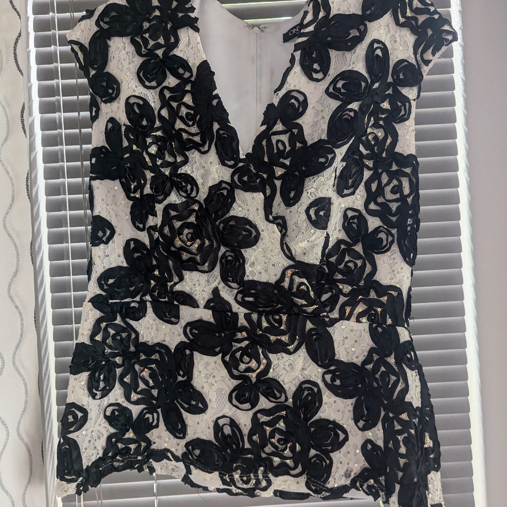 Black white and sequined peplum top